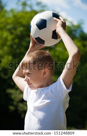 Boy throws a ball for football.