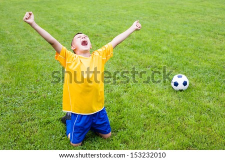 Excited boy football player after goal scored.