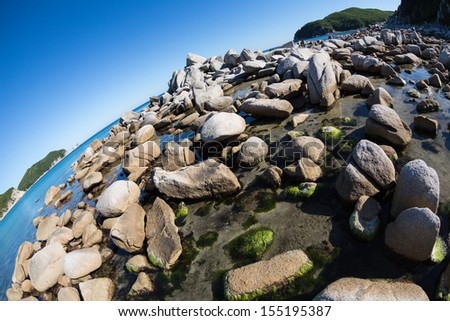 Summer landscape of rocky sea coast. Japan sea. Fish-eye lens.