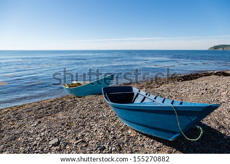 Wooden fishing boats on the sea pebble beach. Russia. Japan sea.