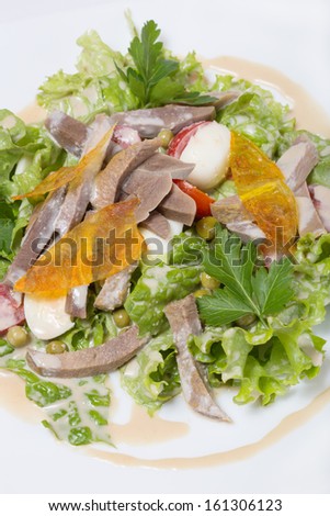 Warm salad with beef tongue, with quail eggs and ginger dressing.