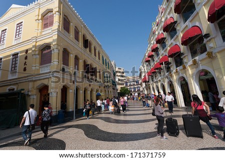 MACAU, CHINA - NOVEMBER 3, 2012: Tourists visit the Historic Center of Macau. Historic Center of Macau was inscribed on UNESCO World Heritage List in 2005.