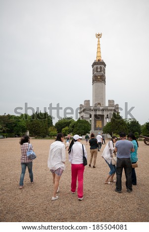 LUSHUN, CHINA - JUNE 10, 2012: Tourists at monument to Soviet soldiers, russian name Port Arthur, is now a naval base in China. Here was the main epicenter of the Russian - Japanese War of 1904-1905.