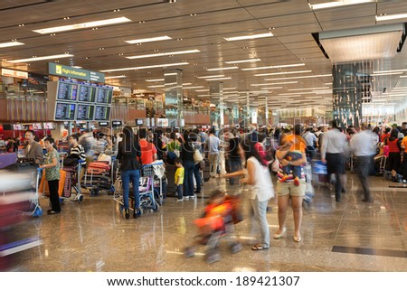 SINGAPORE - NOVEMBER 09, 2012: Passengers in the Singapore Changi Airport lounge. Singapore airport is the main aviation hub in South East Asia.