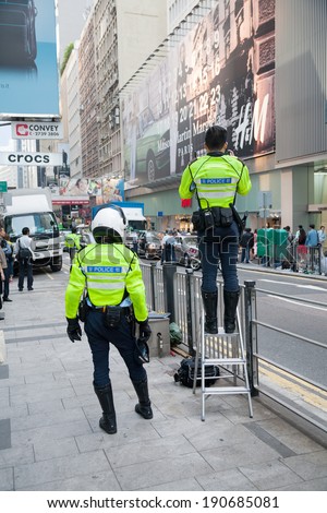 HONG KONG - NOVEMBER 14, 2012: Police men on the Queen\'s Road. Hong Kong has a unified police force - Hong Kong Police Force, it is considered one of the top notch organizations in world.