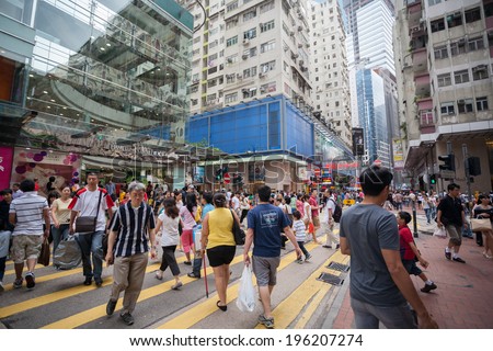 HONG KONG - NOVEMBER 1, 2011: Pedestrians in a crosswalk Causeway Bay district in Hong Kong. Causeway Bay is a heavily built-up area of Hong Kong, located on Hong Kong Island.