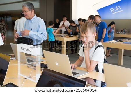 HONG KONG, CHINA - JUNE 18, 2014: Buyers and shop assistants at Apple store in Hong Kong. Store is in a shopping center IFC Mall, it is very popular with locals and tourists visiting Hong Kong.