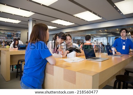 HONG KONG, CHINA - JUNE 15, 2014: Buyers and shop consultants at Apple store in Hong Kong. Store is in a shopping center IFC Mall, it is very popular with locals and tourists visiting Hong Kong.