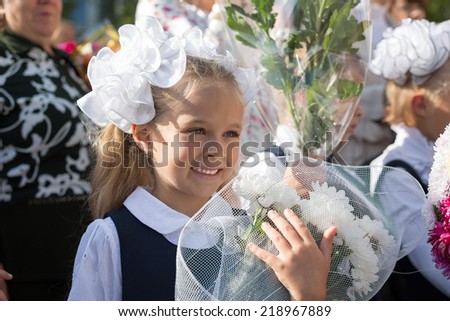 First grader little girl in the first day of training at the school. Russia.