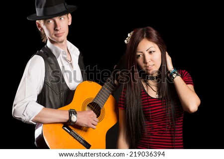 Young musicians performing a song. Interracial young couple, Asian woman and Caucasian man.
