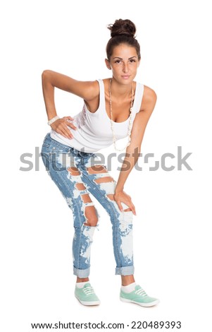 Stylish young woman in torn jeans.