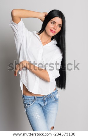 Beautiful girl model in torn jeans looking away. Woman twenty-six years.
