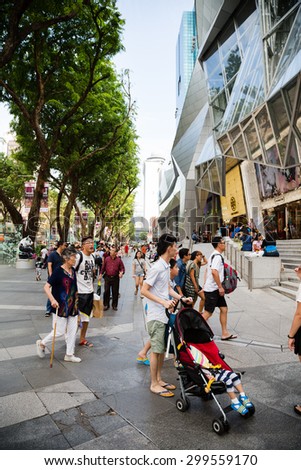 SINGAPORE - CIRCA FEBRUARY, 2015: People walk in the entertainment area at the mall ION Orchard - one the best shopping centers on Orchard Road. In the mall more than 300 shops of the famous brands.