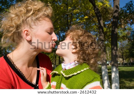Mom kisses the daughter.