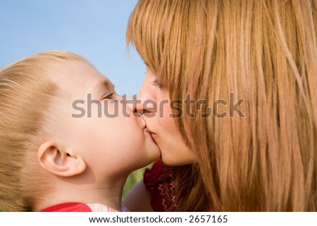 Mom kisses the favourite son.