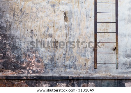 Wall of an old house with a ladder.