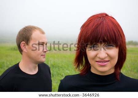 Happy young married couple on the nature. On a background a fog.
