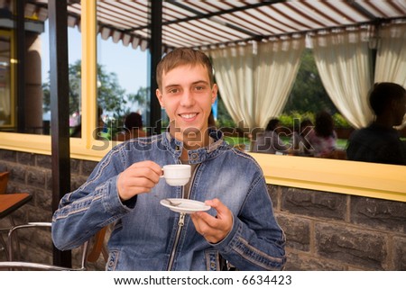 Restaurant for students.The young man drinks coffee.