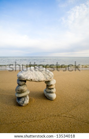 Abstract arch from a natural stones on a background of the sea