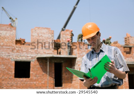 Construction worker.Construction of the house from a brick.