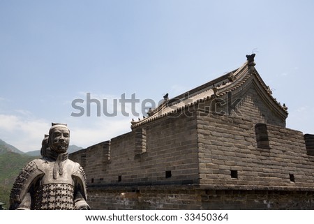 Chinese ancient stone warriors statues and tower on Great Wall of China. Near Beijing.