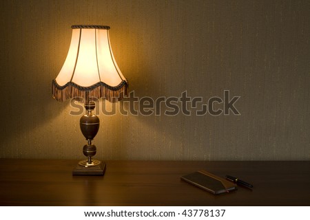 Lamp Shade, notebook and pen on a working table.