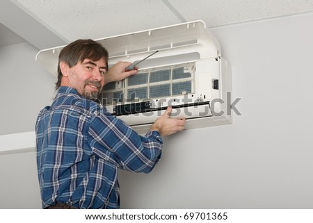 Repairer conducts adjustment of the indoor unit air conditioner.