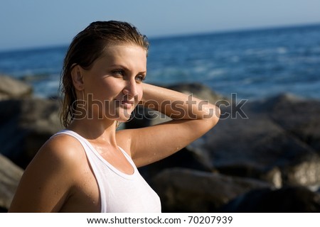 Relaxed attractive girl after a swim in the sea. Evening light.