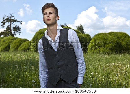 Good looking beautiful young man in classical suit pose outdoor
