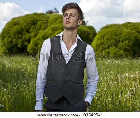 Good looking beautiful young man in classical suit pose outdoor