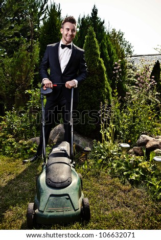 Glamour gardener mows a grass with lawn-mower