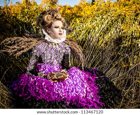 Dramatized image of sensual girl symbolizing autumn. Art Fashion outdoor photo.