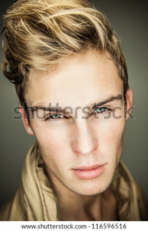 Closeup portrait of sensual man with beautiful face and eyes.