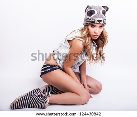 Young sensual model woman on cat hat pose in studio.