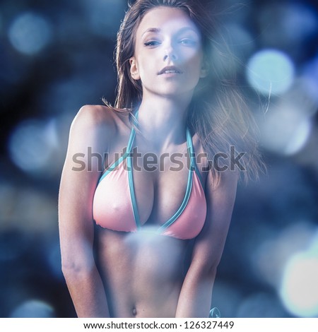 Young sensual model girl. Multicolored face art studio surreal photo.