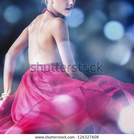 Young sensual model girl - close-up pink dress in motion. Multicolored cut studio surreal photo.
