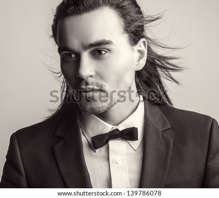 Elegant young handsome man. Black-white studio fashion portrait.