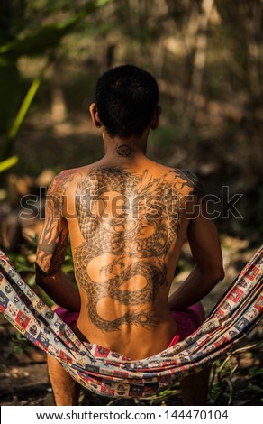 Man with tattoo dragon on his back.