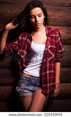 Young sensual & beauty woman in casual clothes pose on grunge wooden background.