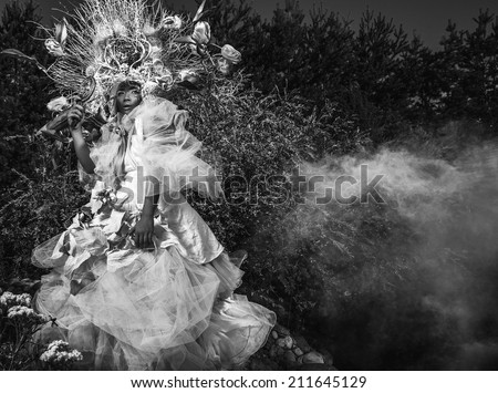 Fashion image of sensual girl in bright fantasy stylization. Black-white outdoor fairy tale art photo.