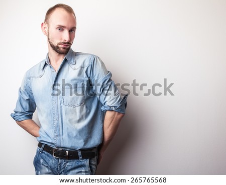 Young handsome man in jeans clothes. Studio fashion portrait.