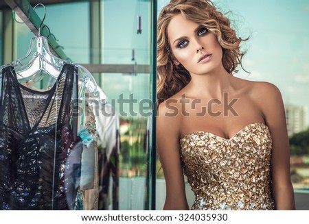 Elegant young beauty woman in luxury dress posing indoor. Fashion photo.