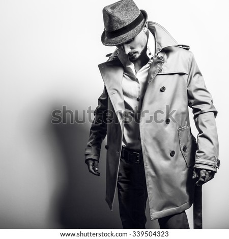 Elegant handsome man in stylish coat. Black-white photo.