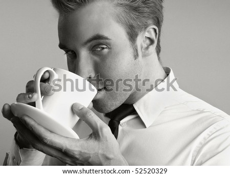Black&White photo of Young attractive businessman drinking coffee