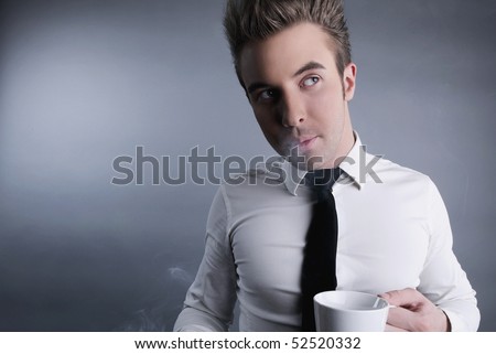 The young worker with bad habits. Coffee and cigarettes.