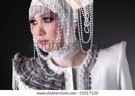 Portrait of Attractive model in exclusive design clothes on manners old-slavic. Photo.