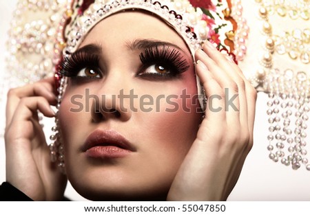 Attractive model in exclusive design clothes on manners old-slavic. Close-up face.