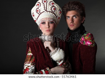 Pair models in exclusive design clothes on manners old-slavic. Photo.