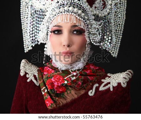 Attractive model in exclusive design clothes on manners old-slavic. Close-up face.