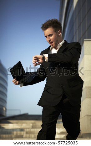 Checking the time. Worried young businessman